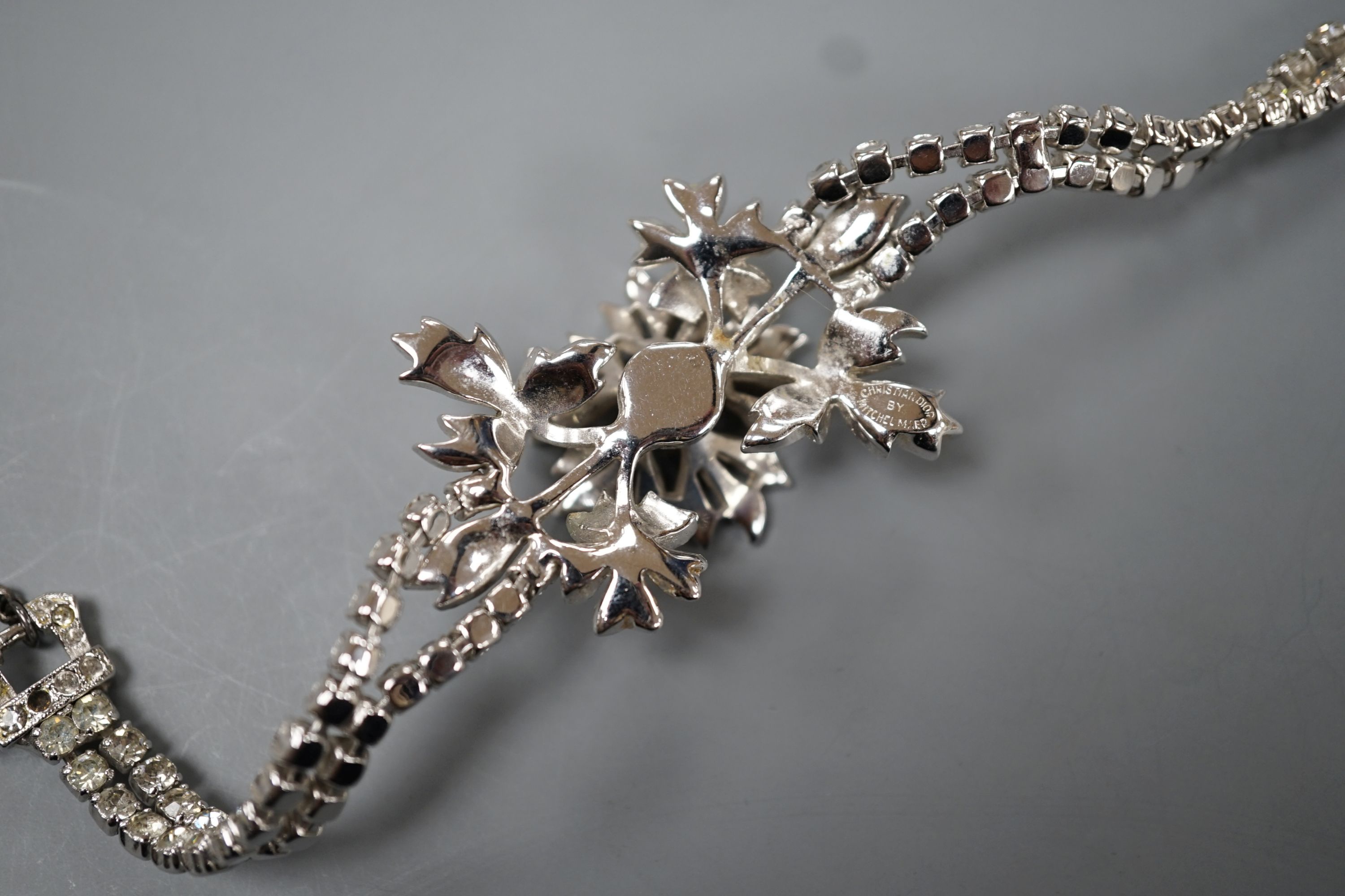 A Christian Dior paste cluster set bracelet, with central en tremblent floral motif, 19cm.